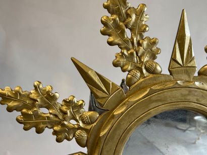 Circular view mirror in gilded wood, with...