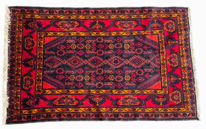 Hand-knotted wool rug on a red background...