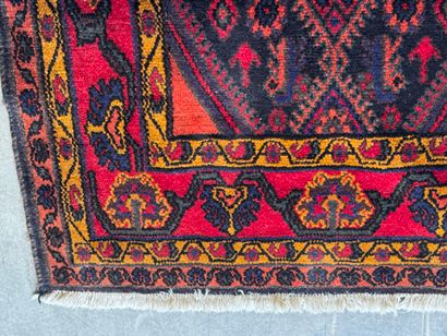 Hand-knotted wool rug on a red background...