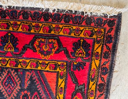 Hand-knotted wool rug on a red background...