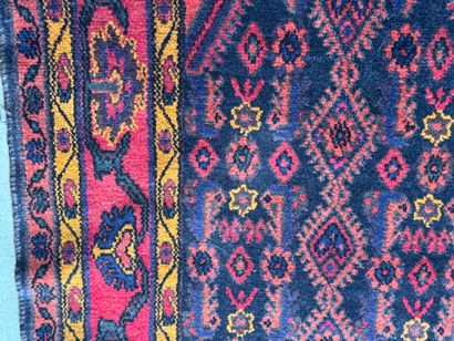 Hand-knotted wool rug on a red background...