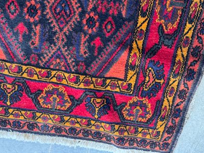 Hand-knotted wool rug on a red background...