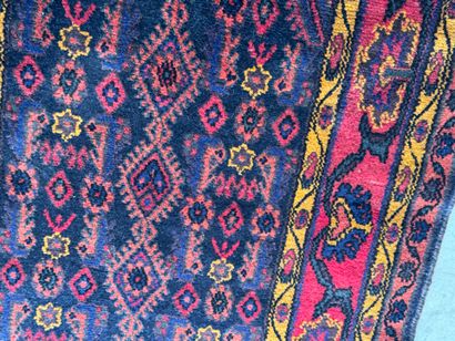Hand-knotted wool rug on a red background...
