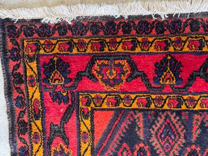 Hand-knotted wool rug on a red background...