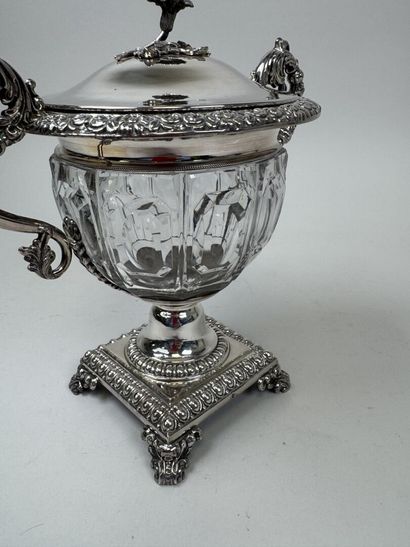 A jam jar or candy dish made of faceted glass...