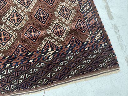 Hand-knotted wool rug featuring stylized...