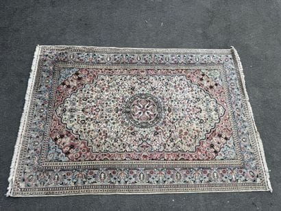 A large, hand-knotted wool rug featuring...