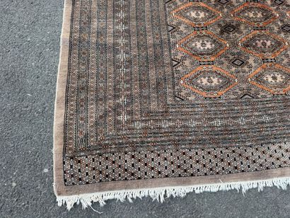Large hand-knotted wool rug featuring stylized...