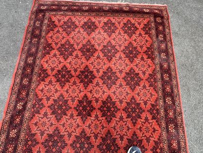 Hand-knotted wool rug with an orange background.
215...