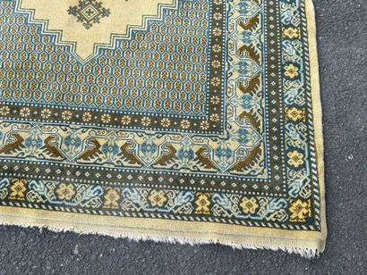 Hand-knotted wool rug featuring stylized...