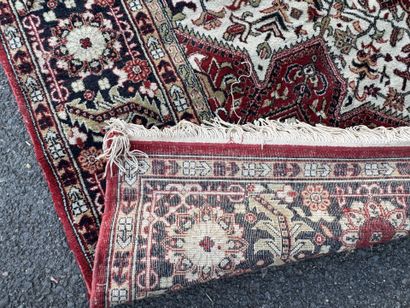 Machine-woven wool rug with a knotted design...