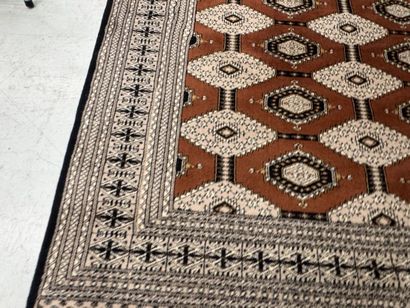 Large machine-woven wool rug featuring geometric...
