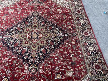 Machine-woven wool rug with a knotted design...