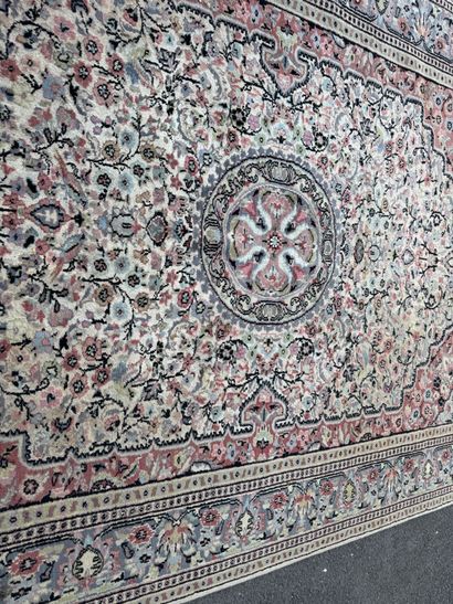 A large, hand-knotted wool rug featuring...