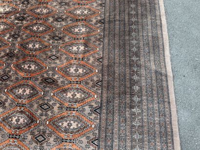 Large hand-knotted wool rug featuring stylized...