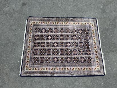 Hand-knotted wool rug with a blue background.
122...