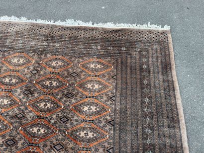 Large hand-knotted wool rug featuring stylized...