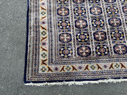 Hand-knotted wool rug with a blue background.
122...