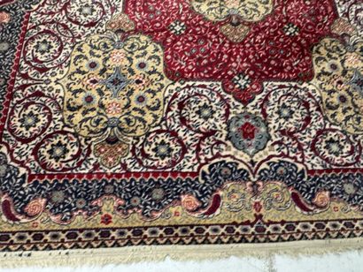 A significant hand-knotted wool rug featuring...