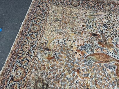 A significant hand-knotted wool rug featuring...
