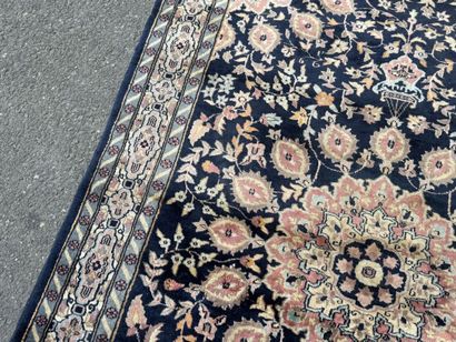 Hand-knotted wool rug featuring a foliage...