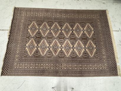 Large machine-woven wool rug featuring geometric...
