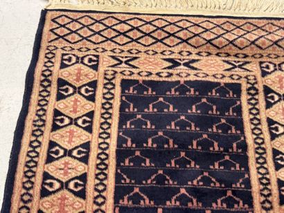 Small hand-knotted wool rug with stylized...