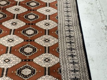Large machine-woven wool rug featuring geometric...