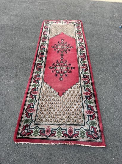 Hand-knotted wool gallery rug with a decorative...