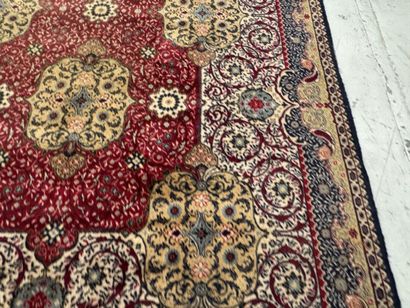 A significant hand-knotted wool rug featuring...