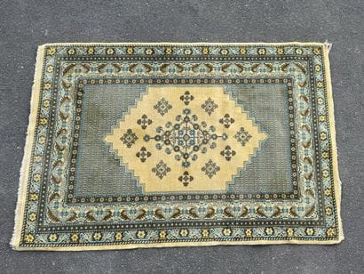 Hand-knotted wool rug featuring stylized...