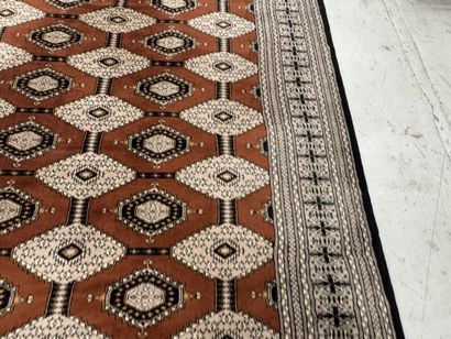 Large machine-woven wool rug featuring geometric...