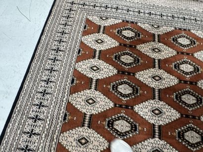 Large machine-woven wool rug featuring geometric...