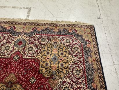 A significant hand-knotted wool rug featuring...