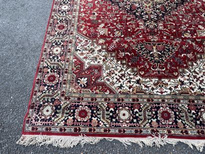 Machine-woven wool rug with a knotted design...
