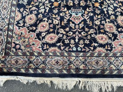 Hand-knotted wool rug featuring a foliage...