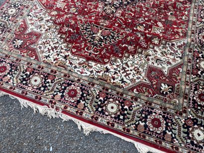 Machine-woven wool rug with a knotted design...