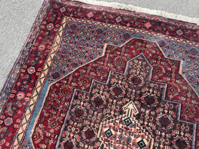 Hand-knotted wool rug featuring stylized...