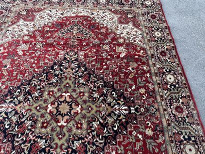 Machine-woven wool rug with a knotted design...