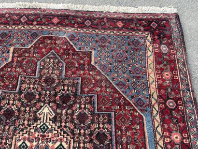 Hand-knotted wool rug featuring stylized...