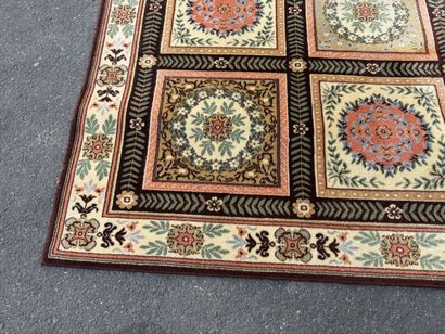 Large, multicolored machine-woven rug featuring...