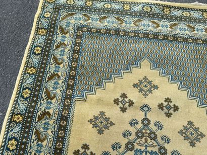 Hand-knotted wool rug featuring stylized...