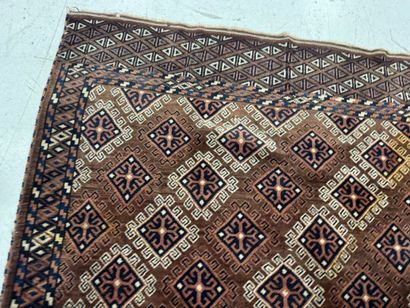 Hand-knotted wool rug featuring stylized...