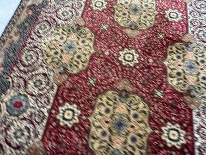 A significant hand-knotted wool rug featuring...