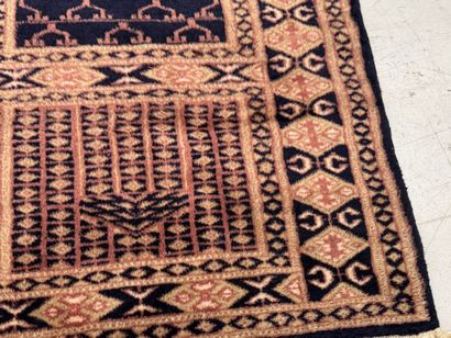Small hand-knotted wool rug with stylized...