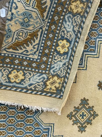 Hand-knotted wool rug featuring stylized...