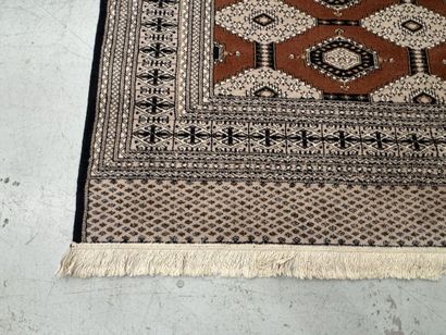 Large machine-woven wool rug featuring geometric...