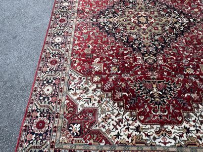 Machine-woven wool rug with a knotted design...