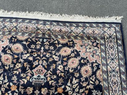 Hand-knotted wool rug featuring a foliage...
