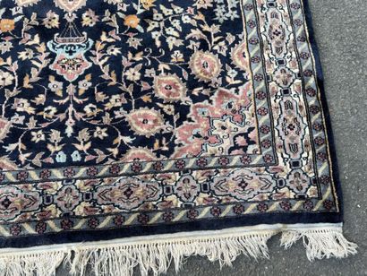 Hand-knotted wool rug featuring a foliage...